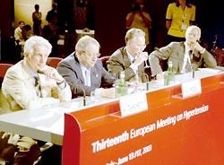 Two Italian doctors, Alberto Zanchetti, left, and Giuseppe Mancia, second from right, sipping water, led efforts to update global hypertension guidelines. Both have ties to drug companies.