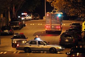 Police surround a house in Seattle's Leschi neighborhood Sunday night. A woman leaving the home told them Maurice Clemmons was there and bleeding, a source said. 