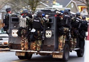 Seattle police SWAT members leave a house in the Leschi neighborhood Monday after finding no sign of suspect Maurice Clemmons. 