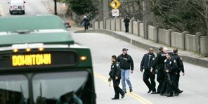 University of Washington and Seattle police officers cross 15th Avenue Northeast after a futile search for Clemmons in Cowen Park. The park and some neighborhood streets were closed temporarily. 