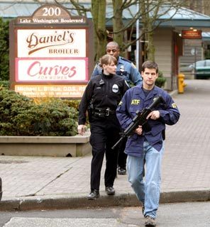 Seattle police officers and an agent from the federal Bureau of Alcohol, Tobacco and Firearms (ATF) search the Leschi neighborhood along Lake Washington Boulevard. 