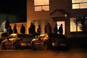 Police enter a house on South 132nd Street and Renton Avenue South after securing the area. 