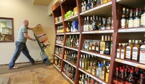 Bryan Van Selus wheels in new inventory Thursday for University Liquor and Wine as final work is under way to stock the shelves of the new state liquor store at 5105 25th Ave. N.E., part of a Merrill Gardens retirement-community complex. 