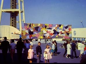 With the Horiuchi Mural as a backdrop, Enid, Scott and Phoebe Gilbert enjoy a day at the Seattle World's Fair in 1962. 