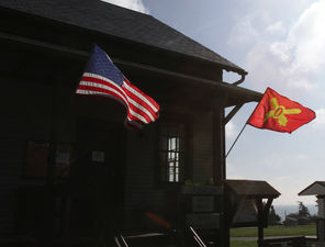The Stars and Stripes and the flag of crossed cannons of the coast artillery battalion that served there during World War II and the Korean War fly in front of the fort's museum. 