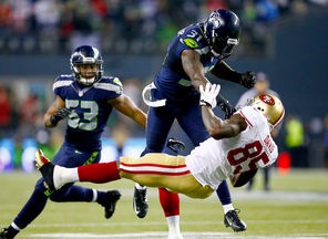 Seahawks safety Kam Chancellor (31) sends a clear message to San Francisco  tight end Vernon Davis in the second half of the NFC Championship Game.