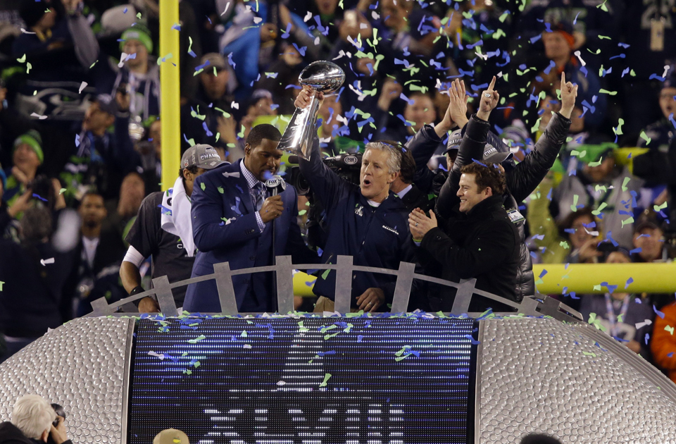 The Seattle Seahawks won their first Super Bowl in franchise history with a 43-8 victory over the Broncos at MetLife Stadium in New Jersey on Feb. 2. Seattle was lifted by a relentless defense that forced four turnovers and some big plays, including an 87-yard kickoff return by Percy Harvin. Above, coach Pete Carroll holds the Lombardi Trophy aloft as he and general manager John Schneider celebrate the Hawks' historic win.