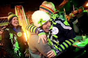 Monica Atkinson, white hat, hugs Stephanie Powell at Fuel Sports Bar in Pioneer Square after the Seahawks made a big play against the Denver Broncos on Sunday.