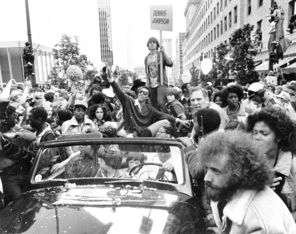 <strong>1979:</strong> Dennis Johnson waves as the SuperSonics NBA championship parade is mobbed in downtown Seattle on a warm June day.