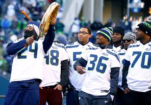 Marshawn Lynch bangs a drum during the Super Bowl XLVIII victory rally at CenturyLink Field.