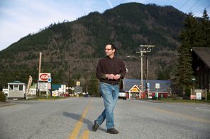 Darrington Mayor Dan Rankin crosses the road Monday  after a news conference.  “I’m trying to hold it together all day long,” he said later at a town meeting.