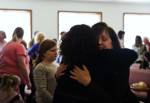 Members of the congregation of Glad Tidings Assembly of God in Darrington greet and hug one another at services on Sunday.