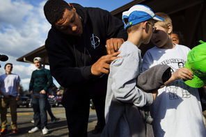 Seattle Seahawks linebacker Malcolm Smith autographs 9-year-old Aksel Espeland's T-shirt outside the Darrington Community Center on Monday. Twelve players from the Seahawks and the Seattle Sounders visited Darrington to lend support to the town east of the deadly mudslide. The athletes
