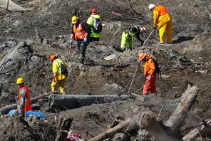 Workers dig at a much drier mudslide site on the west side of the mudslide on Highway 530 near mile marker 37 near Oso on Tuesday. Officials fear the debris could divert spring runoff into a new channel along the Highway 530 corridor and threaten homes downstream.