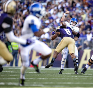 Washington’s Hau’oli Kikaha (8) puts a serious hit on Georgia State’s  Nick Arbuckle who was still able to get the pass off toward  Donovan Harden. Arbuckle was 18 of 24, 184 yards in the first half.