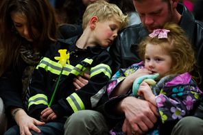 Members of the Brooks family of Arlington embrace during a prayer service in April at Haller Middle School in Arlington, one of many community gatherings to show support and gratitude in the aftermath of the Highway 530 mudslide. From left are Kelly, Logan, Dane and Gwendolyn Brooks 