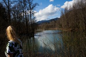 Wendy Wagner watches the water levels of the Stillaguamish River rise along Highway 530 in March. The mudslide changed the course of the river and of the lives of the people living along it. In the months that followed, they have been quietly putting their lives back together.